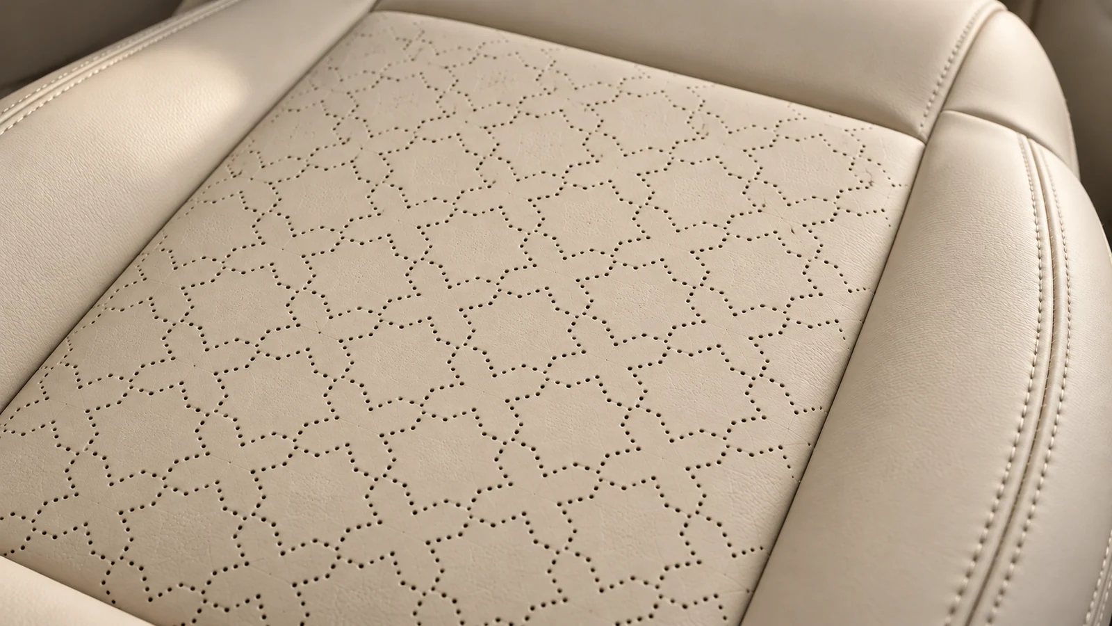 Bone leather with geometric perforations and fine stitching